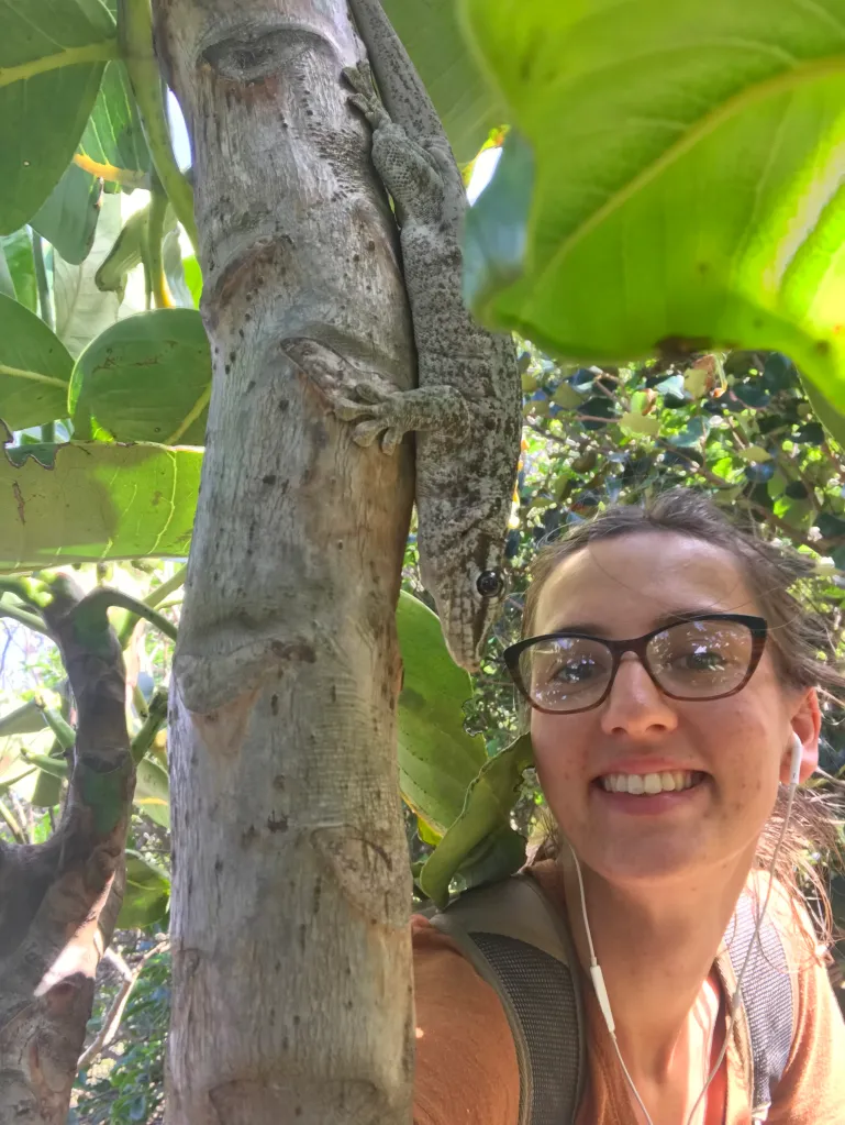 Bethan Govier beside a lizard in a tree