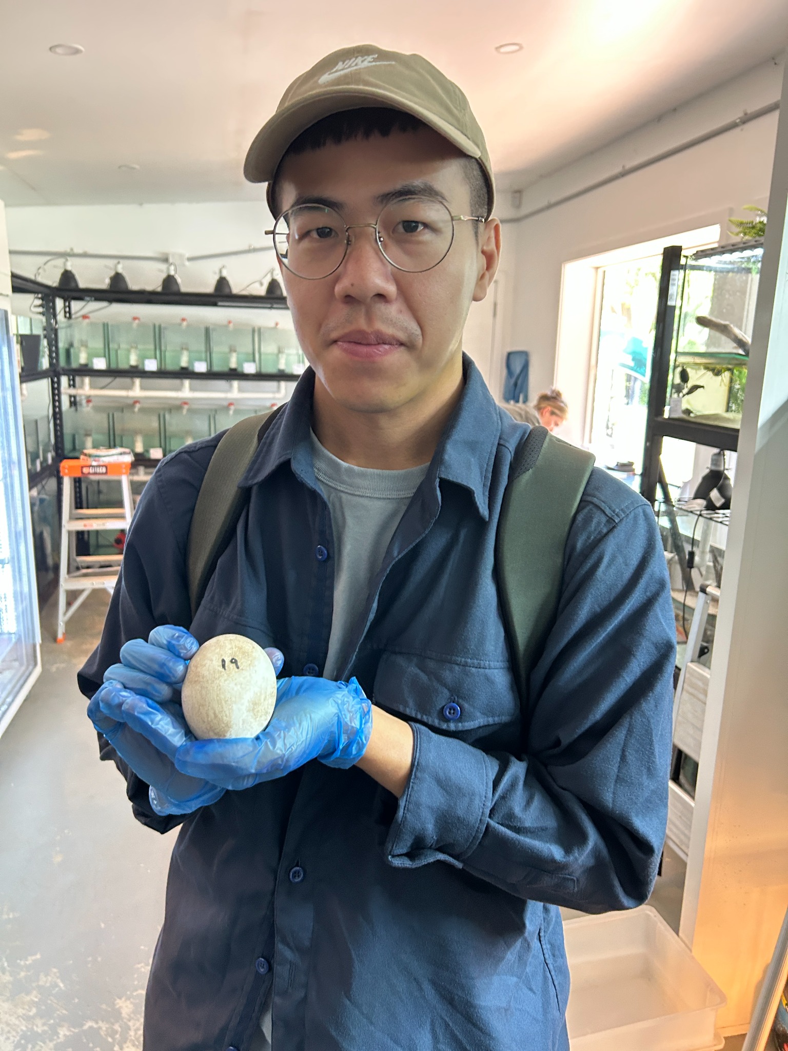 Chien-Chen Huang holding a reptile egg