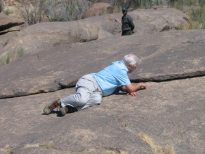 David Attenborough in the field surrounded by flat lizards at Augrabies Falls National Park.